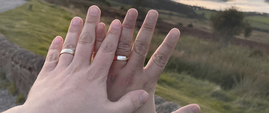 LGBTQ couple wearing WOOLTON & HEWITT diamond engagement rings