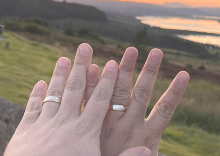 Two men showing their WOOLTON & HEWITT diamond engagement rings after their proposal.